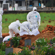 Paramedics prepare to bury a victim of the Nipah virus outbreak in Kerala, India.